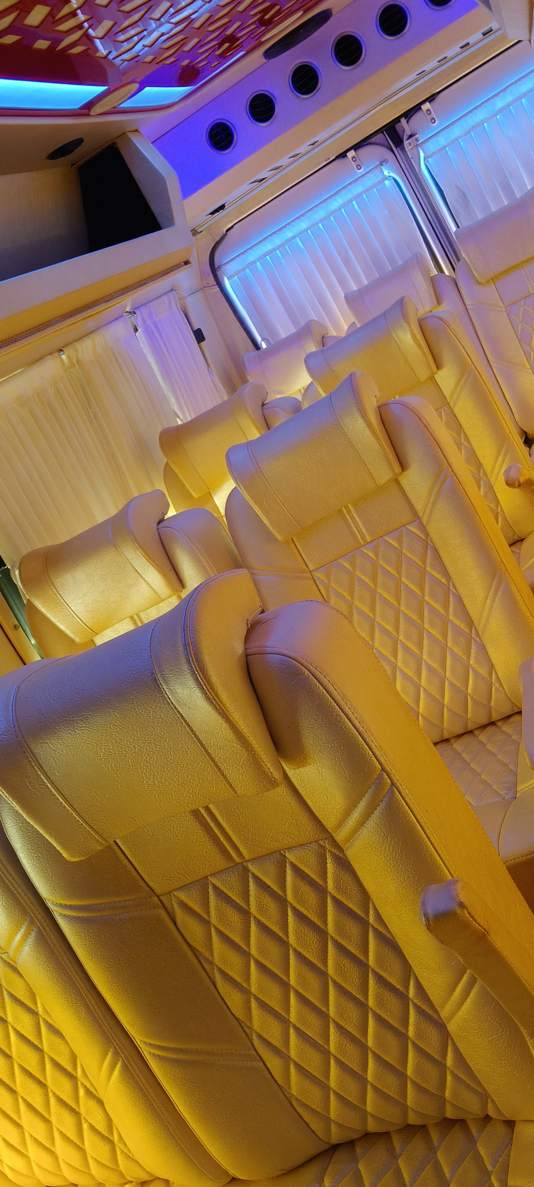 Inside a JSM Tempo Traveller — cushioned reclining seats